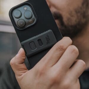 User holding a phone equipped with Tango Tango's PTT button